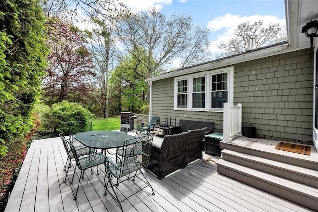 wooden terrace featuring an outdoor living space, a grill, and outdoor dining space