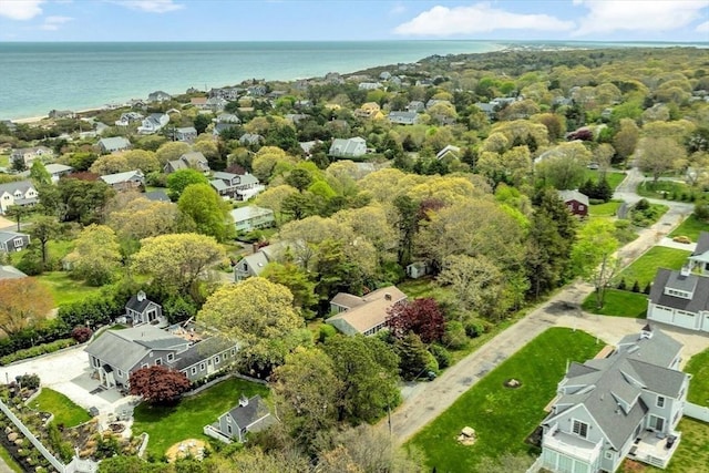 aerial view of property and surrounding area featuring a nearby body of water and nearby suburban area