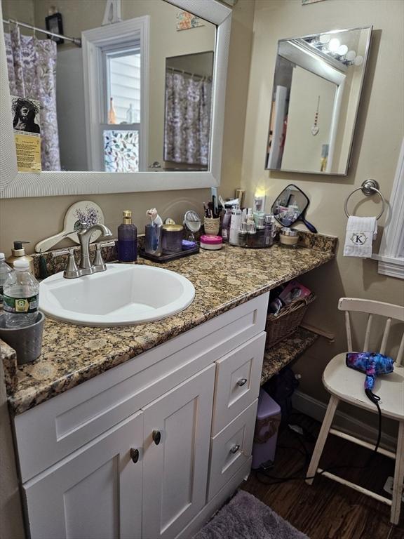 26 Harvard Unit C, Ayer, MA 01432 - bathroom featuring vanity, a shower with curtain, and wood finished floors