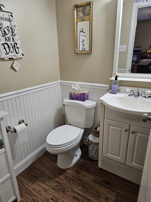 26 Harvard Unit C, Ayer, MA 01432 - bathroom with vanity, toilet, wood finished floors, and wainscoting
