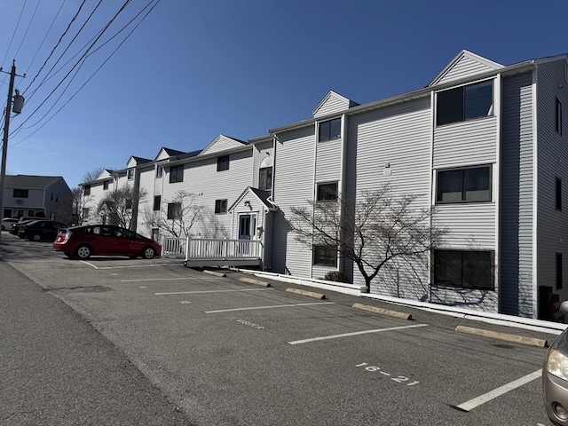 view of property featuring uncovered parking and a residential view