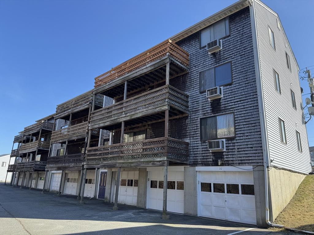 view of building exterior featuring a wall mounted AC