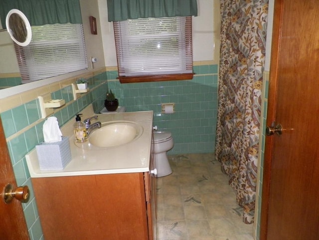 7 Maple Ln, Millbury, MA 01527 - bathroom with toilet, vanity, tile walls, wainscoting, and curtained shower