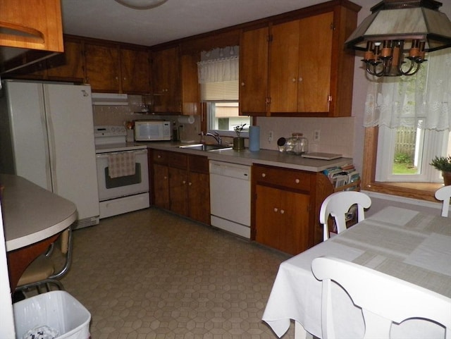7 Maple Ln, Millbury, MA 01527 - kitchen with white appliances, a sink, tasteful backsplash, a chandelier, and under cabinet range hood
