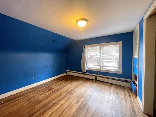 bonus room with hardwood / wood-style flooring and baseboard heating