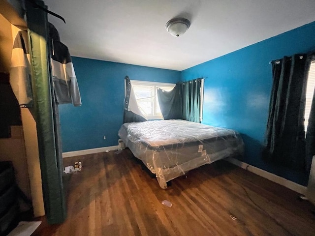 bedroom with dark wood-type flooring