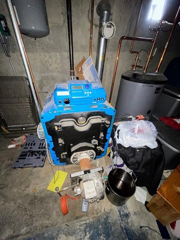 utility room featuring gas water heater