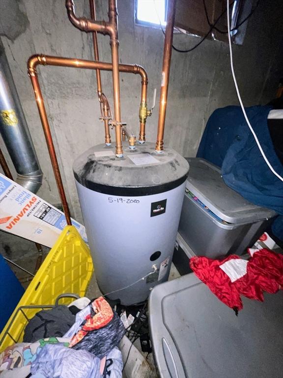 utility room featuring water heater