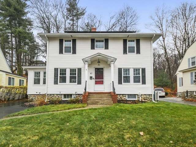 view of front of home with a front lawn and a chimney