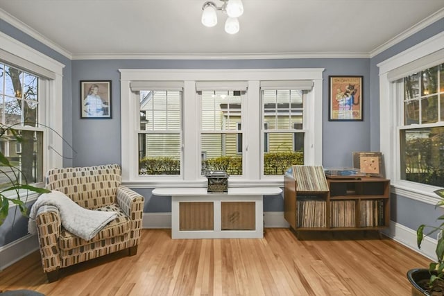 sitting room with crown molding, baseboards, and hardwood / wood-style floors