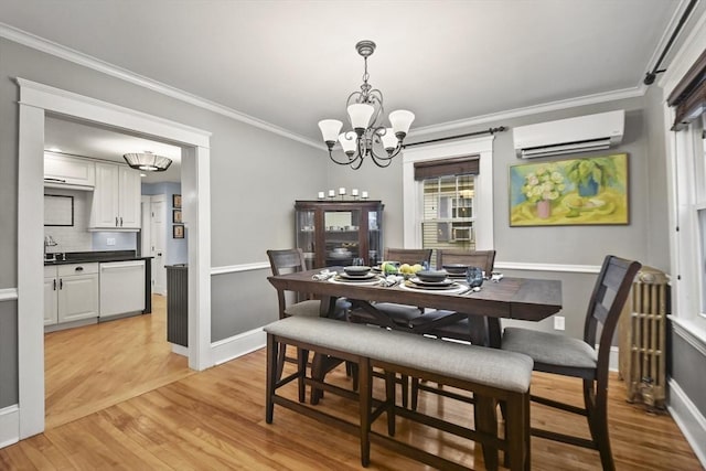 dining space featuring crown molding, baseboards, a chandelier, light wood-type flooring, and a wall mounted AC