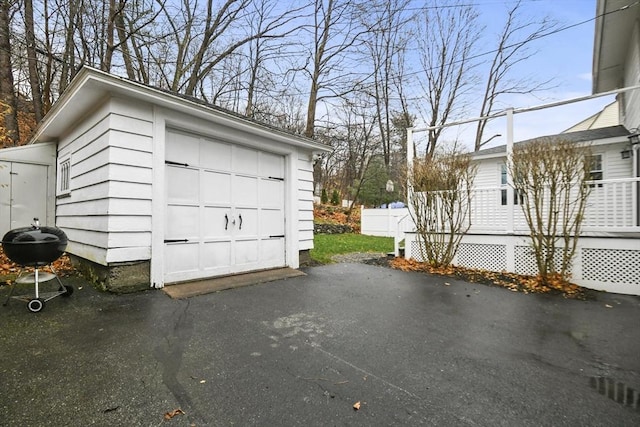 detached garage with driveway and fence