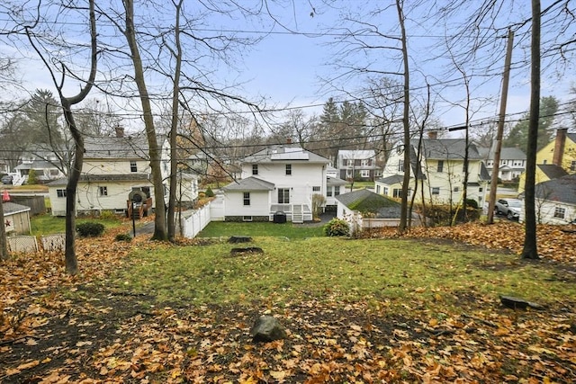 view of yard featuring fence and a residential view