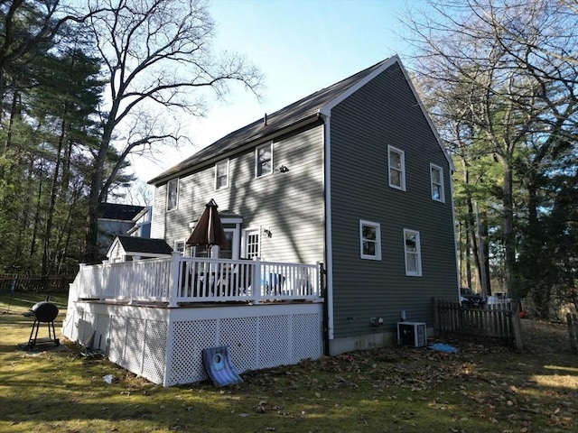 view of side of property with a wooden deck and cooling unit