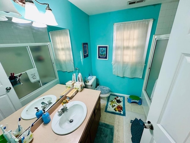 bathroom with vanity, an enclosed shower, and toilet