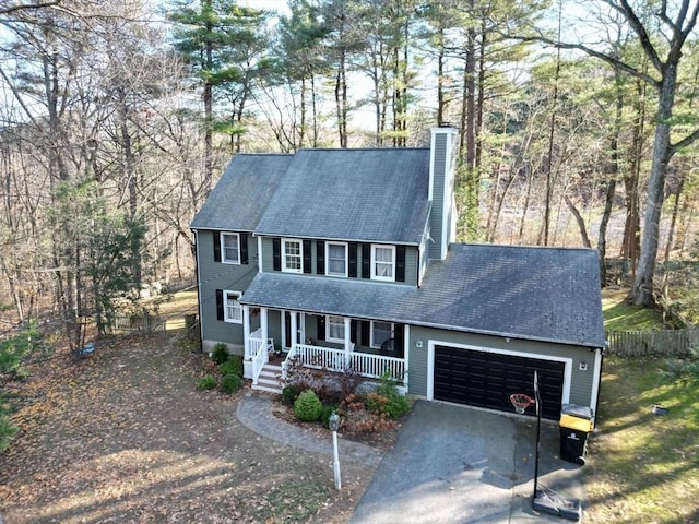 colonial home with a porch and a garage