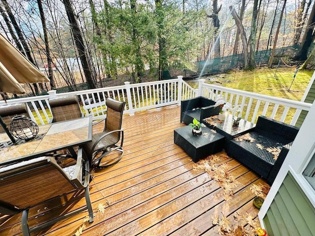 wooden deck with an outdoor living space