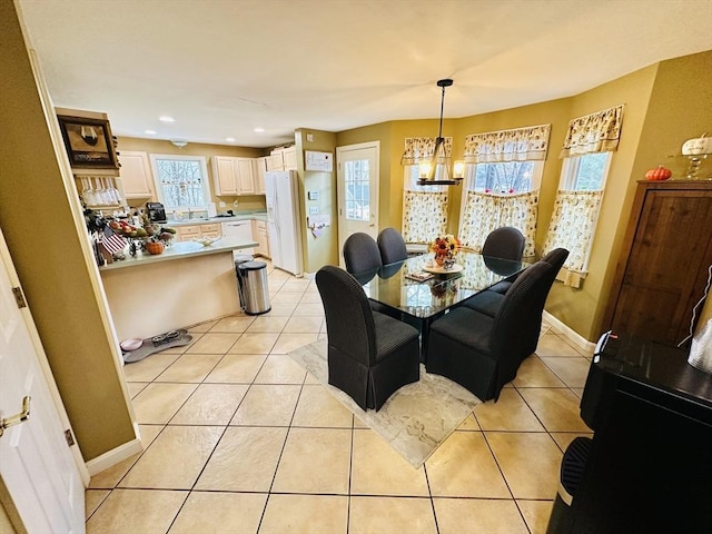 dining room with a chandelier and light tile patterned floors