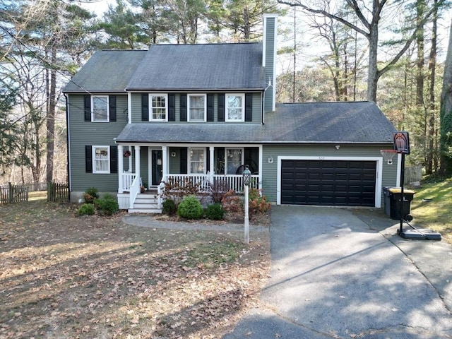 colonial-style house with covered porch and a garage