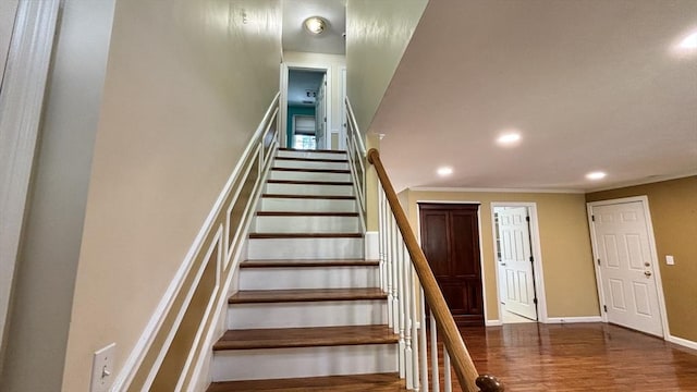stairs with crown molding, baseboards, recessed lighting, and wood finished floors