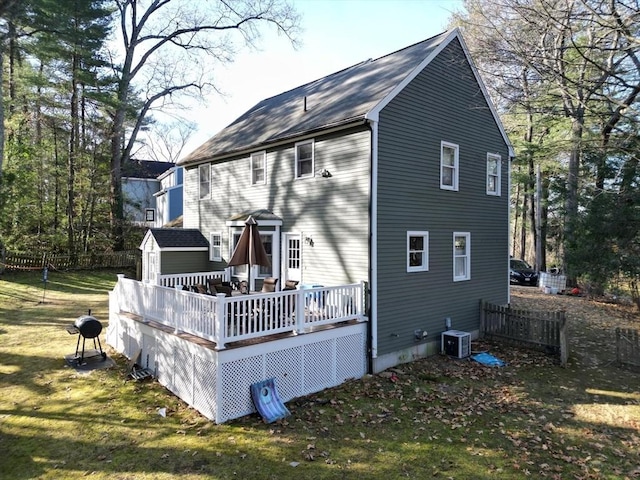 back of house with a lawn, central AC unit, and a deck