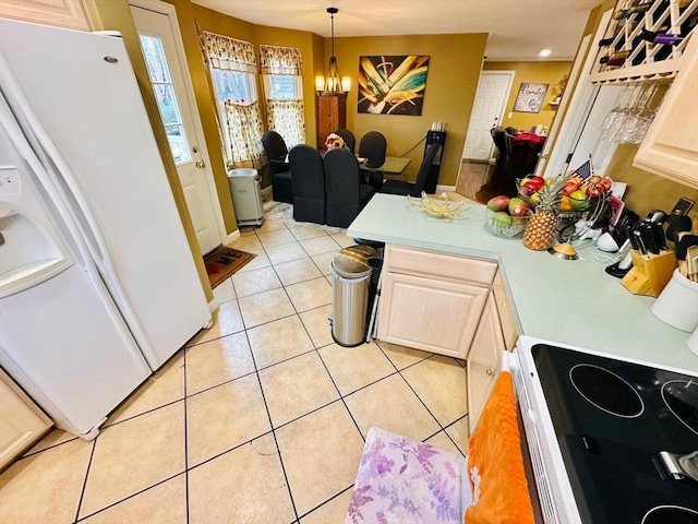 kitchen featuring light tile patterned flooring, stove, an inviting chandelier, hanging light fixtures, and white fridge