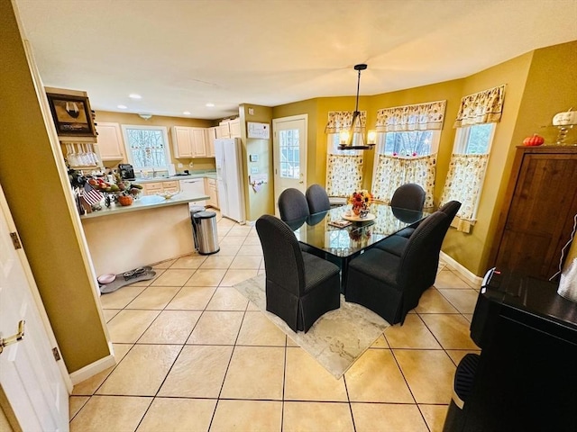 tiled dining area featuring a chandelier