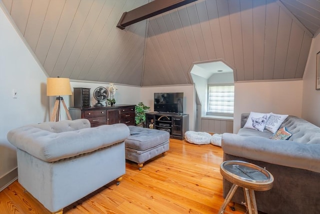 living area featuring light wood finished floors and vaulted ceiling