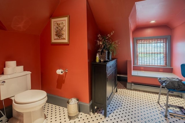 bathroom featuring toilet, baseboards, and lofted ceiling