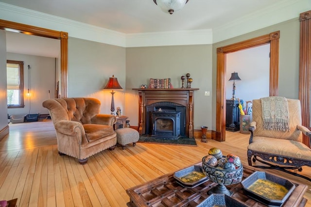 living room with baseboards, crown molding, and hardwood / wood-style flooring