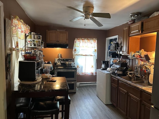 52 Burr St, Springfield, MA 01109 - kitchen featuring range with two ovens, under cabinet range hood, a baseboard heating unit, a sink, and light wood-style flooring