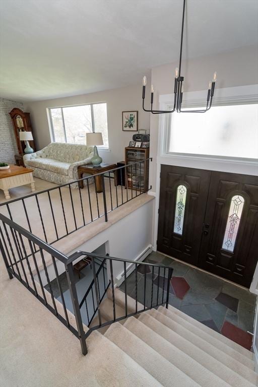 foyer entrance featuring a chandelier and stairway