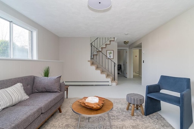 living room with baseboard heating and stairway