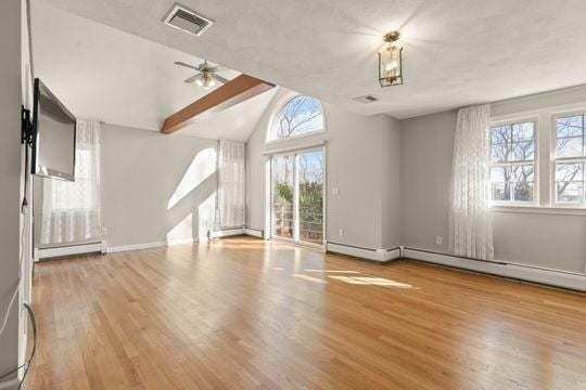 unfurnished living room with baseboard heating, wood finished floors, lofted ceiling, baseboards, and ceiling fan