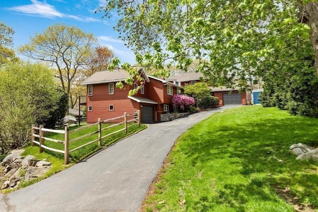 view of front of home featuring asphalt driveway and an attached garage