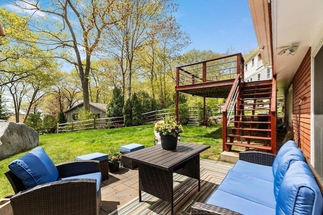 deck featuring stairway, an outdoor hangout area, and a patio