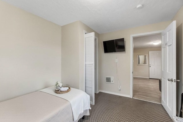 bedroom with carpet floors and a textured ceiling