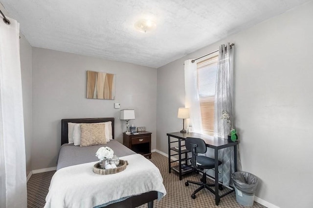 bedroom with carpet floors and a textured ceiling