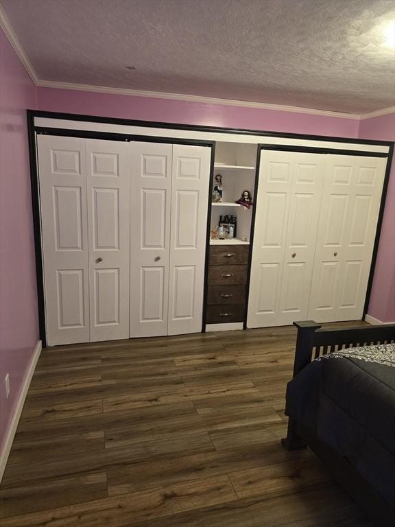 bedroom with ornamental molding, dark hardwood / wood-style flooring, and a textured ceiling