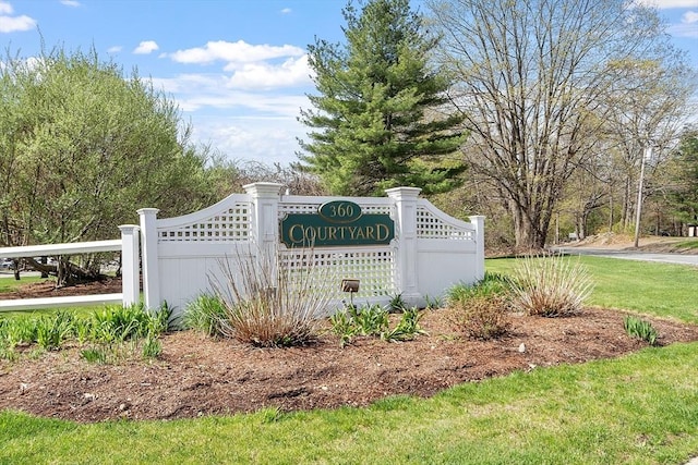 community / neighborhood sign featuring fence