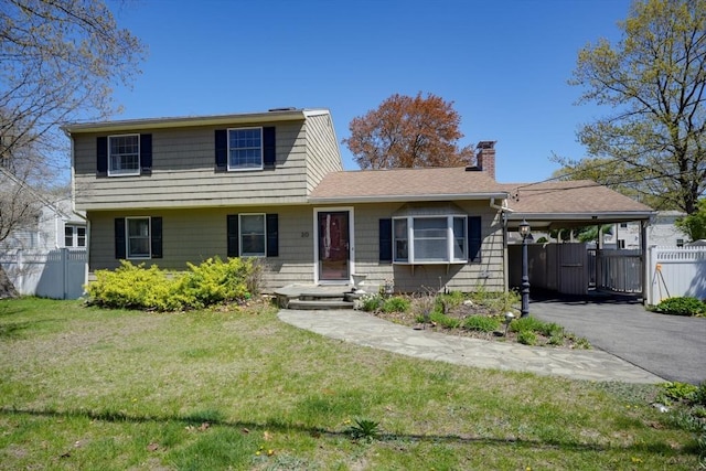 20 Fernglade Rd, Burlington, MA 01803 - view of front of property featuring a chimney, a front yard, fence, aphalt driveway, and an attached carport
