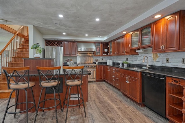 20 Fernglade Rd, Burlington, MA 01803 - kitchen with a kitchen island, wall chimney range hood, a kitchen bar, a sink, and appliances with stainless steel finishes