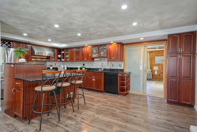 20 Fernglade Rd, Burlington, MA 01803 - kitchen with light wood-style floors, a breakfast bar area, wall chimney exhaust hood, a center island, and black dishwasher
