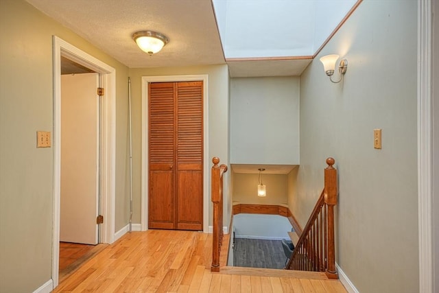 20 Fernglade Rd, Burlington, MA 01803 - hallway with baseboards, wood-type flooring, and an upstairs landing