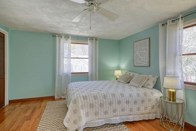 20 Fernglade Rd, Burlington, MA 01803 - bedroom with baseboards, a ceiling fan, a textured ceiling, and wood finished floors
