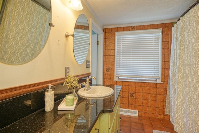 20 Fernglade Rd, Burlington, MA 01803 - bathroom featuring crown molding, a sink, tile patterned floors, tile walls, and visible vents