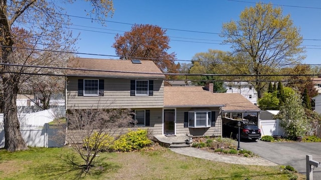 20 Fernglade Rd, Burlington, MA 01803 - view of front facade featuring fence, a chimney, a shingled roof, and a front yard