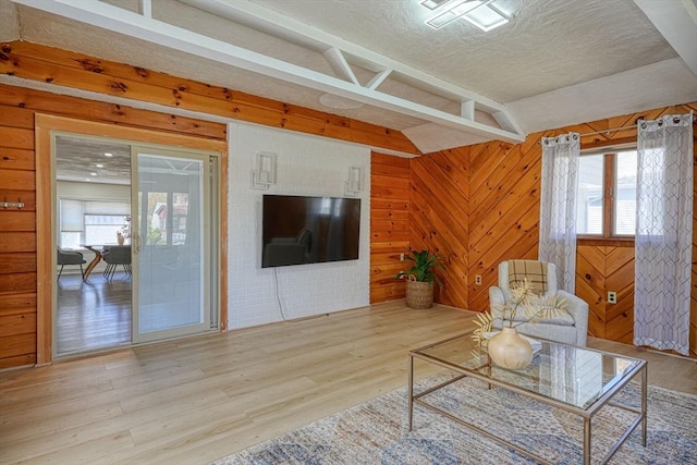 20 Fernglade Rd, Burlington, MA 01803 - unfurnished living room featuring a textured ceiling, wood walls, and wood finished floors