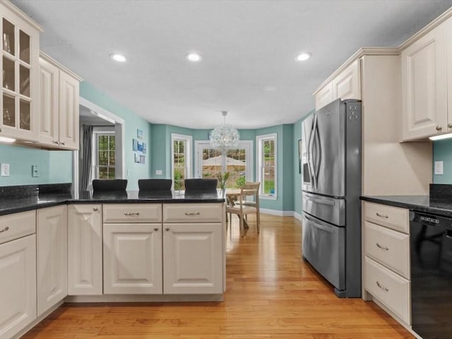 kitchen with stainless steel fridge with ice dispenser, dishwasher, a chandelier, glass insert cabinets, and a peninsula
