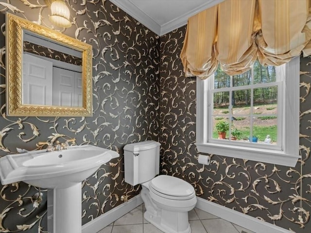 bathroom featuring baseboards, toilet, and ornamental molding